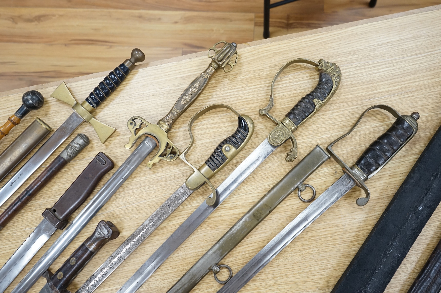 An Imperial German presentation infantry officer’s sword dated 1919/20, another similar with plain blade and brass stirrup hilt, another similar, plain in steel scabbard, a Wilkinson masonic sword probably circa 1950, a